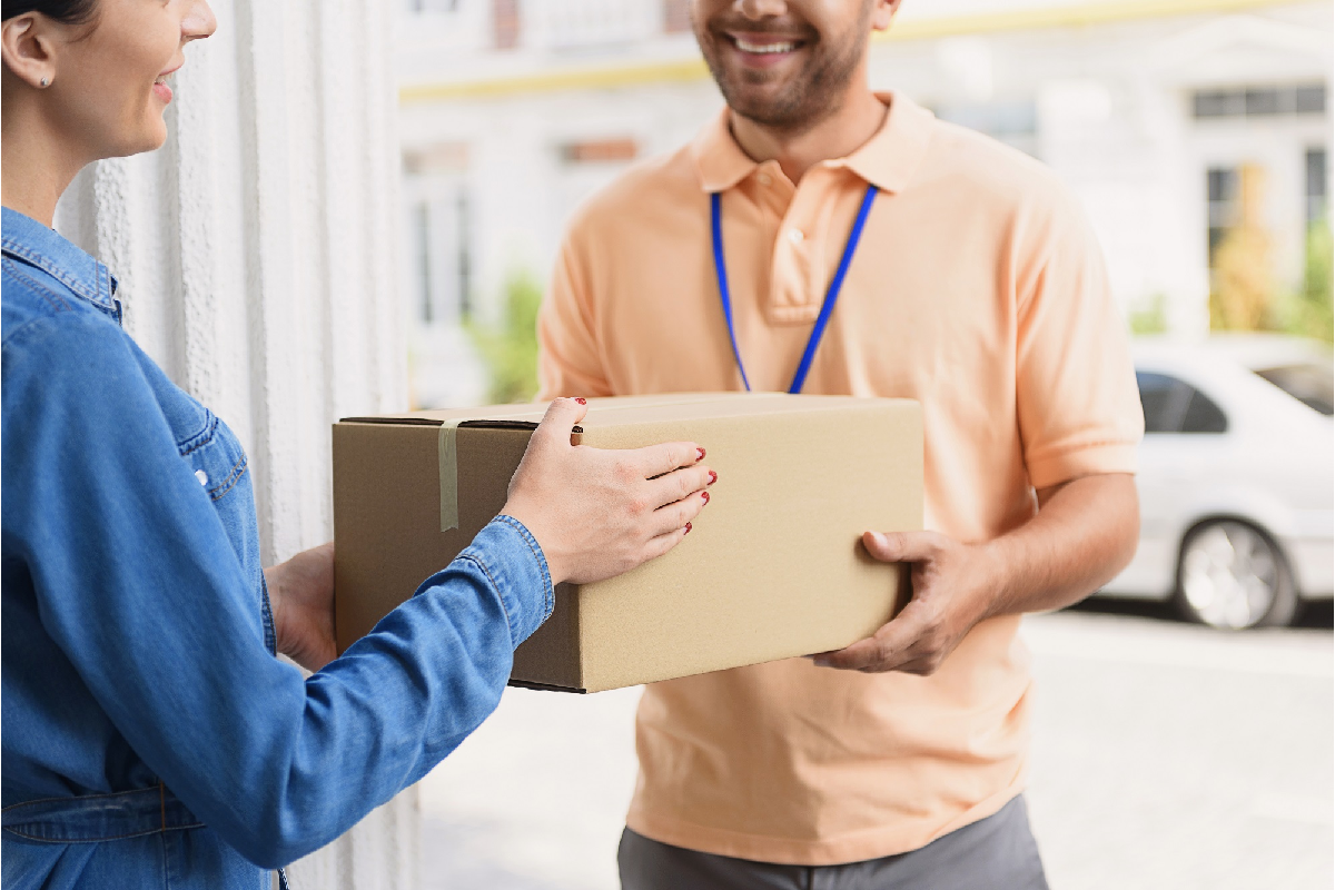 Courier handing off a parcel for Goorooship Canada Inc.